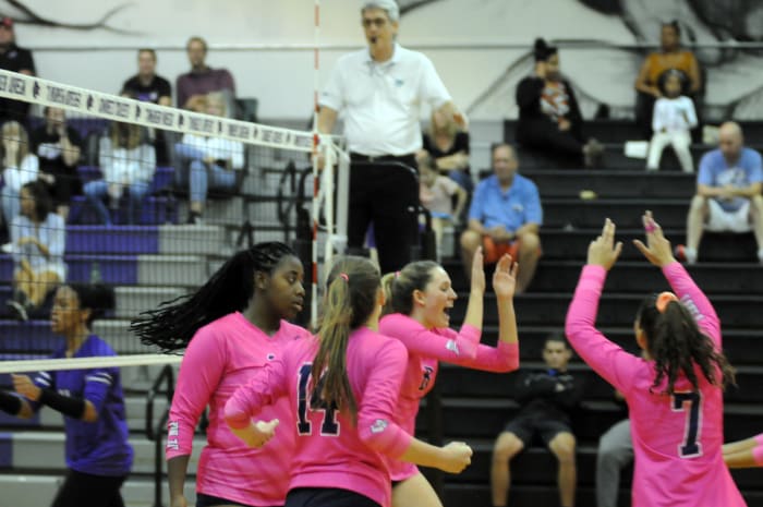 Lake Nona's Emma McDonald (8) celebrates a kill with teammates (from left) Dakota Jean-Louis, Anna Pantano and Jarielys Giraud. McDonald had five kills and two blocks.
